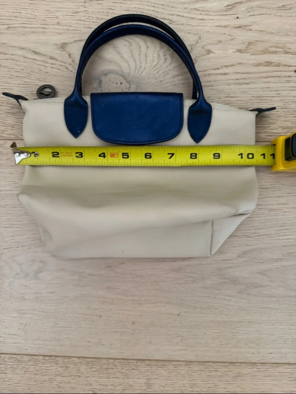 Longchamp Small Le Pliage Cream Tote with Navy Trim. Top zip with snap flap.